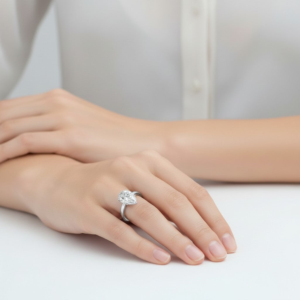 My Store 4 pear cut diamond engagement ring with tulip basket and hidden halo on a woman's hand