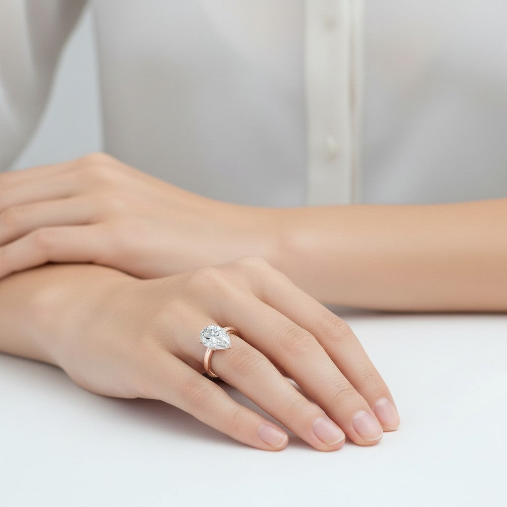 My Store 4 pear cut diamond engagement ring with tulip petal basket and hidden halo on a model's hand