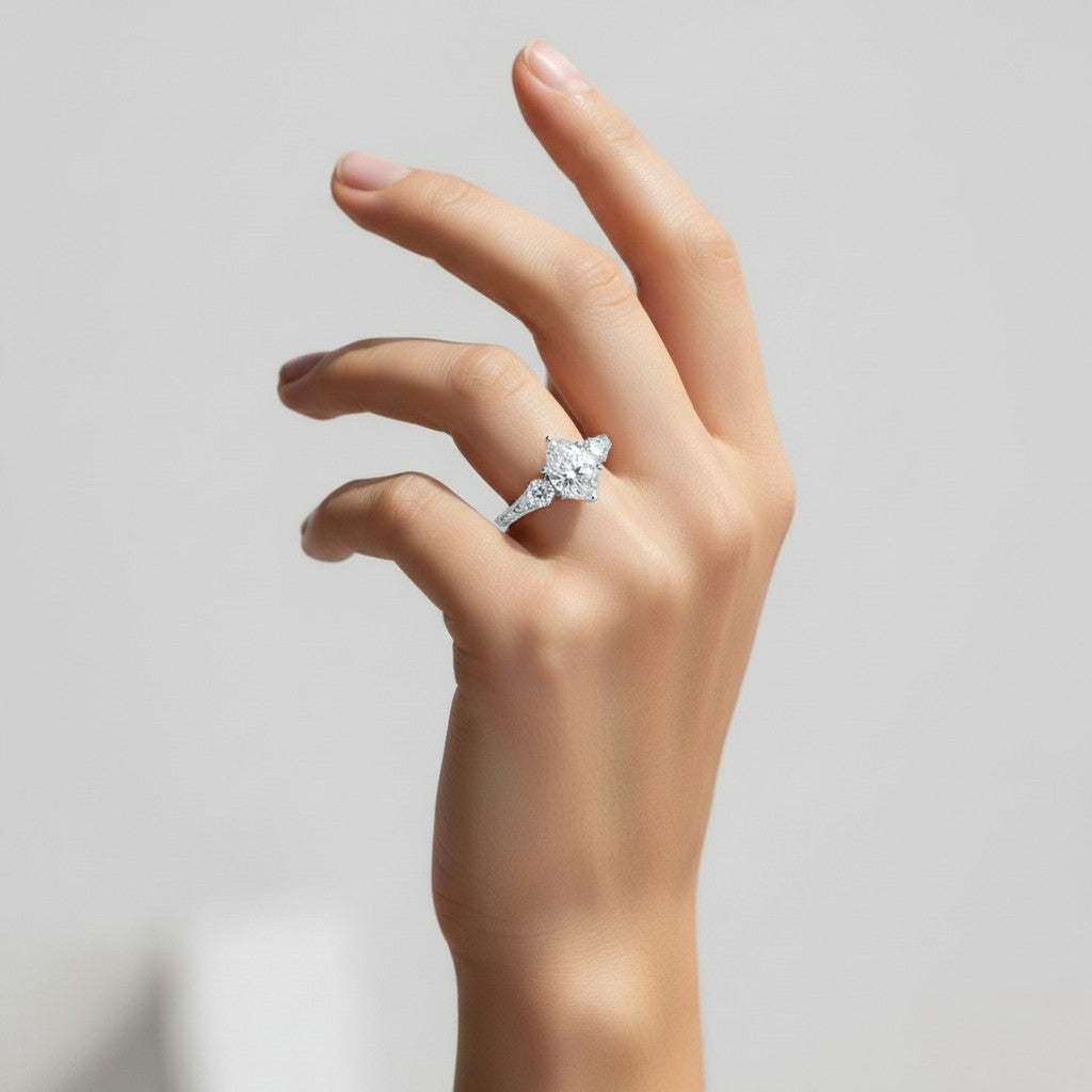 My Store 4 vintage-inspired pear cut three-stone engagement ring with engraved gold band on a woman's hand