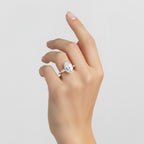 My Store 4 pear cut engagement ring with tapered baguette side diamonds on a woman's hand in solid gold