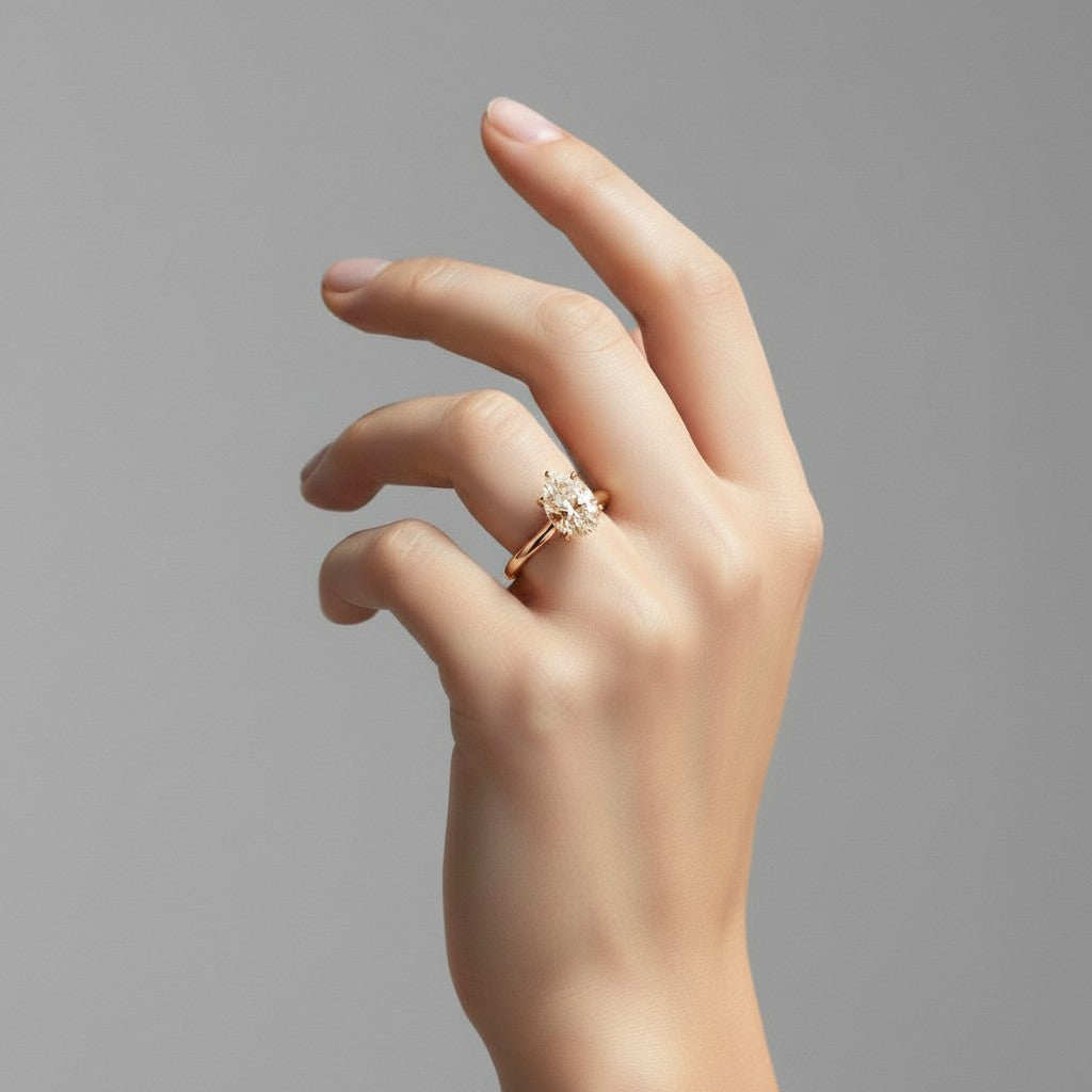 My Store 4 pear cut diamond engagement ring with hidden halo and pavé bridge on a yellow gold band worn on a hand