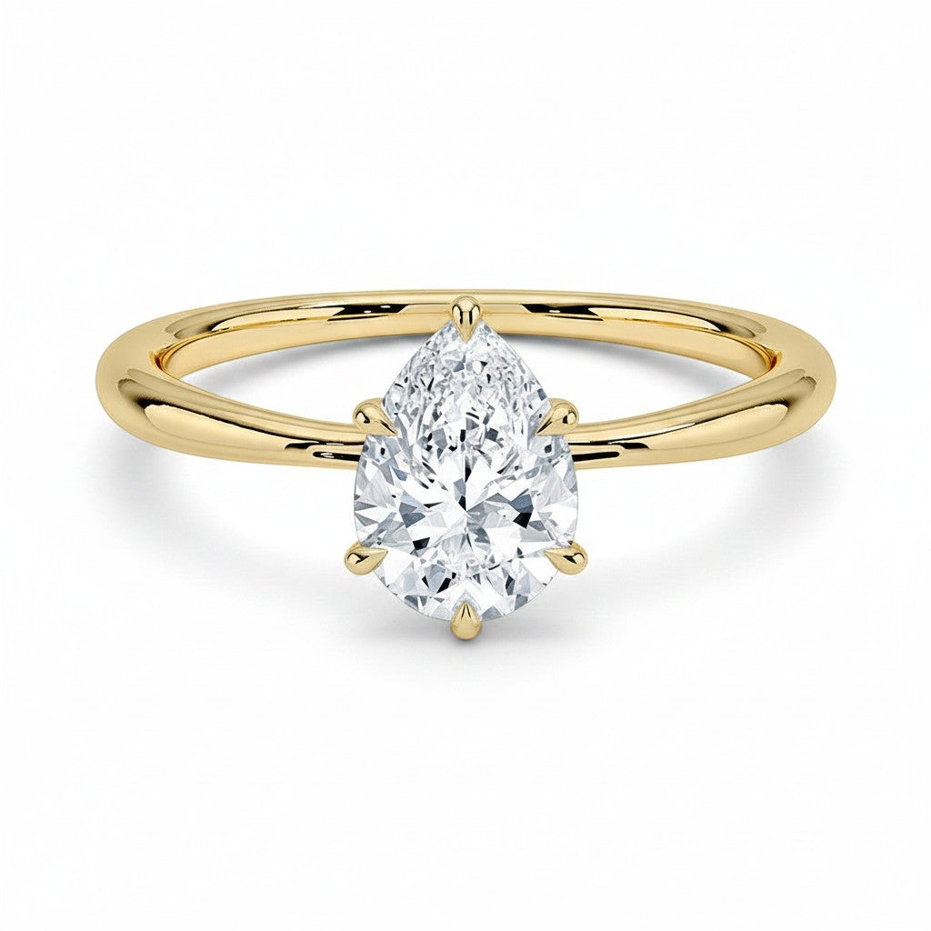 My Store 4 pear cut solitaire engagement ring featuring a brilliant teardrop diamond on a polished 18K yellow gold band.