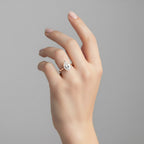 My Store 4 pear cut diamond engagement ring with a hidden halo on a polished yellow gold band worn on a hand