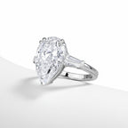 My Store 4 pear cut engagement ring with tapered baguette side diamonds in polished white gold on a white background.