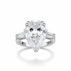 My Store 4 three-stone engagement ring with a pear-cut center diamond and tapered baguette side stones in white gold.