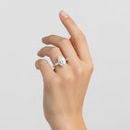 My Store 4 three-stone engagement ring with a pear-cut center diamond and tapered baguette side stones on a gold band.