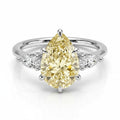 My Store 4 18K solid gold trilogy ring featuring a fancy yellow pear-cut lab-grown diamond with side stones.