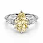 My Store 4 18K solid gold trilogy ring featuring a fancy yellow pear-cut lab-grown diamond with side stones.