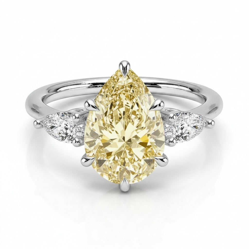 My Store 4 18K solid gold trilogy ring featuring a fancy yellow pear-cut lab-grown diamond with side stones.