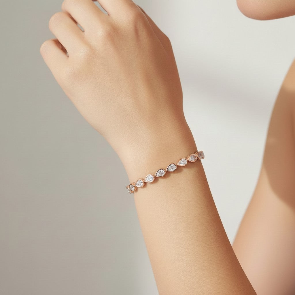 My Store 4 rose gold tennis bracelet featuring pear-cut diamonds in smooth protective bezel settings on a wrist.