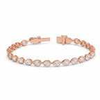 My Store 4 rose gold tennis bracelet featuring pear-cut diamonds in smooth protective bezel settings with a box clasp.