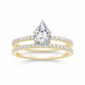My Store 4 pear-cut diamond engagement ring and matching pavé wedding band set in 18K yellow gold.