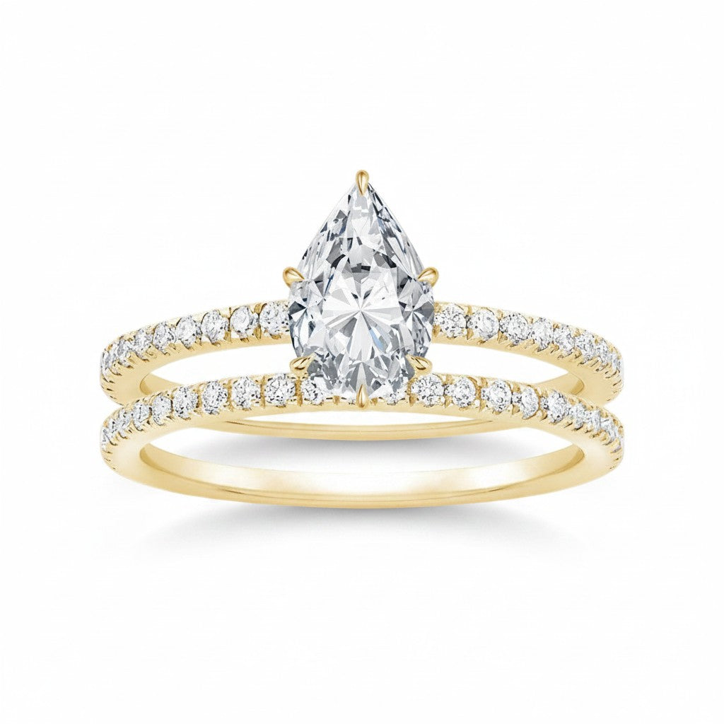 My Store 4 pear-cut diamond engagement ring and matching pavé wedding band set in 18K yellow gold.
