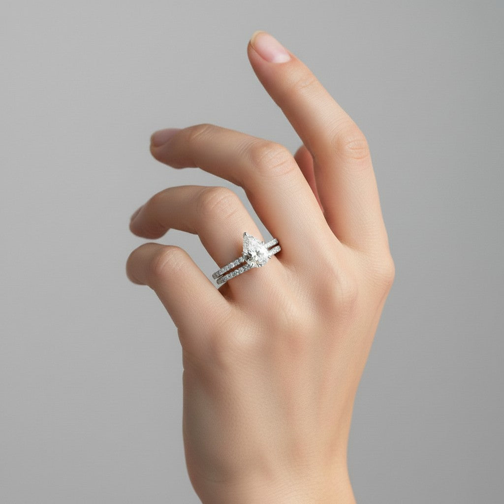 My Store 4 pear diamond engagement ring and matching pavé wedding band set worn on a woman's finger