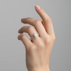 My Store 4 pear-cut diamond engagement ring and matching pavé wedding band set in yellow gold worn on a finger.
