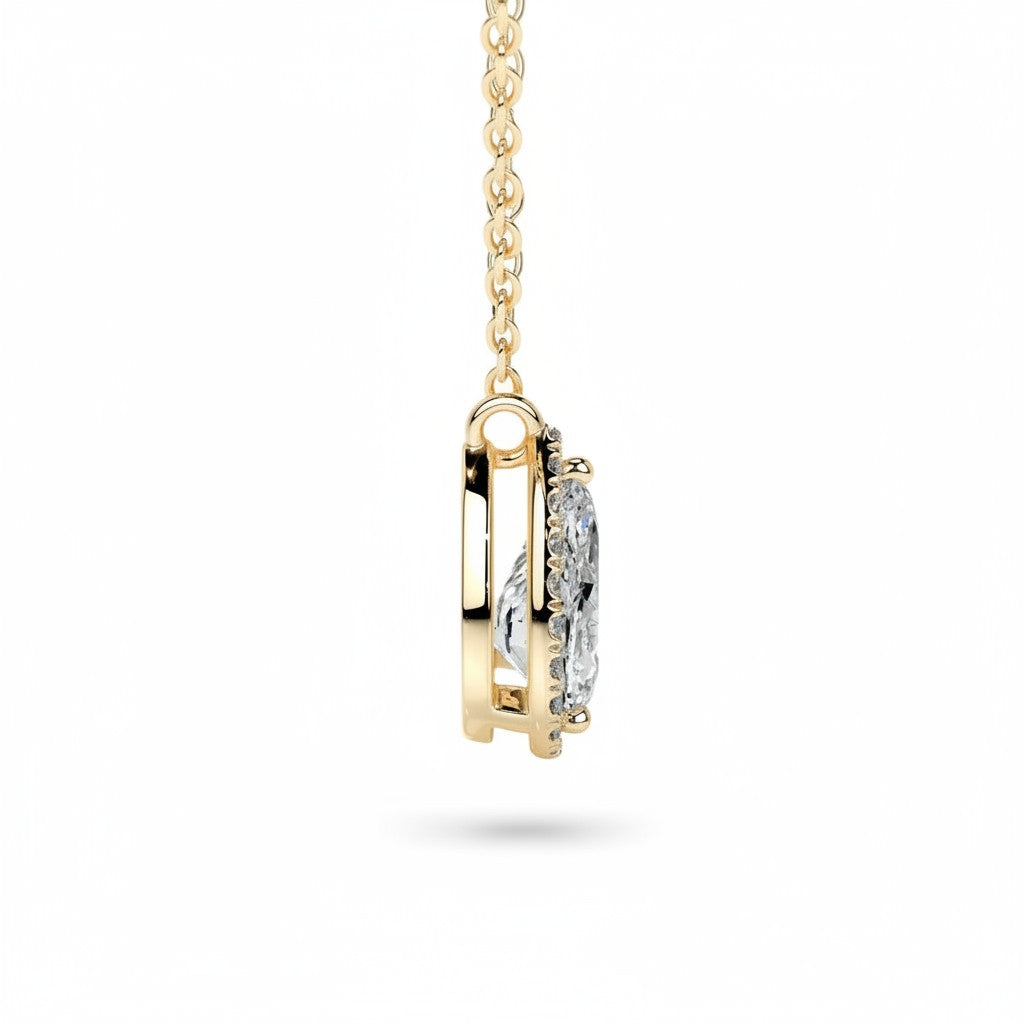 My Store 4 pear halo floating diamond pendant in 18K yellow gold, showing a side profile of the bail-free setting.