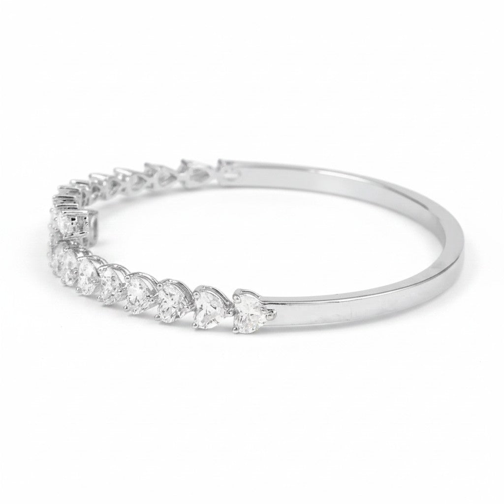 My Store 4 open bangle bracelet in white gold featuring alternating pear and heart cut diamonds in a bypass design.