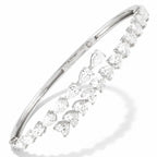 My Store 4 white gold open bangle bracelet featuring alternating pear-cut and heart-cut diamonds in a bypass design.