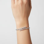 My Store 4 pear and heart diamond bypass open bangle bracelet in white gold worn on a wrist.