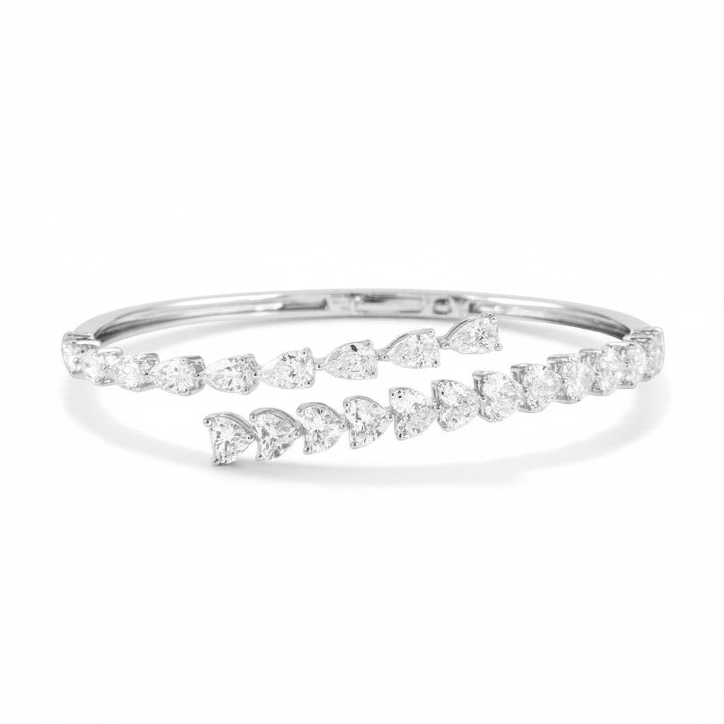 My Store 4 bypass open bangle bracelet in white gold featuring alternating pear and heart cut diamonds.