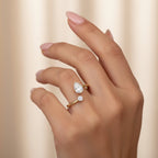My Store 4 bypass engagement ring with pear and round cut diamonds on a polished 18K yellow gold open band.