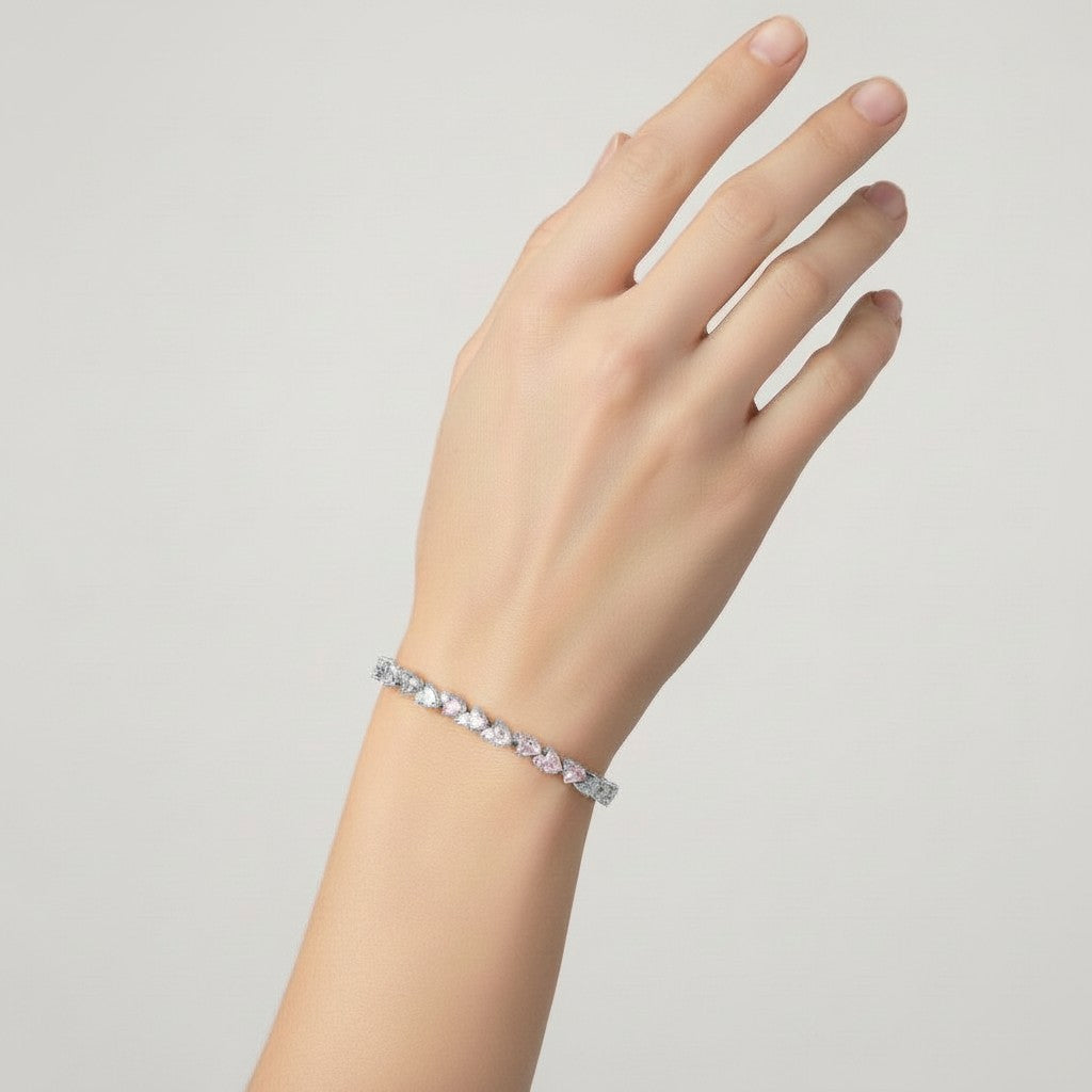 My Store 4 tennis bracelet featuring alternating pear and round diamonds on a woman's wrist in solid gold.