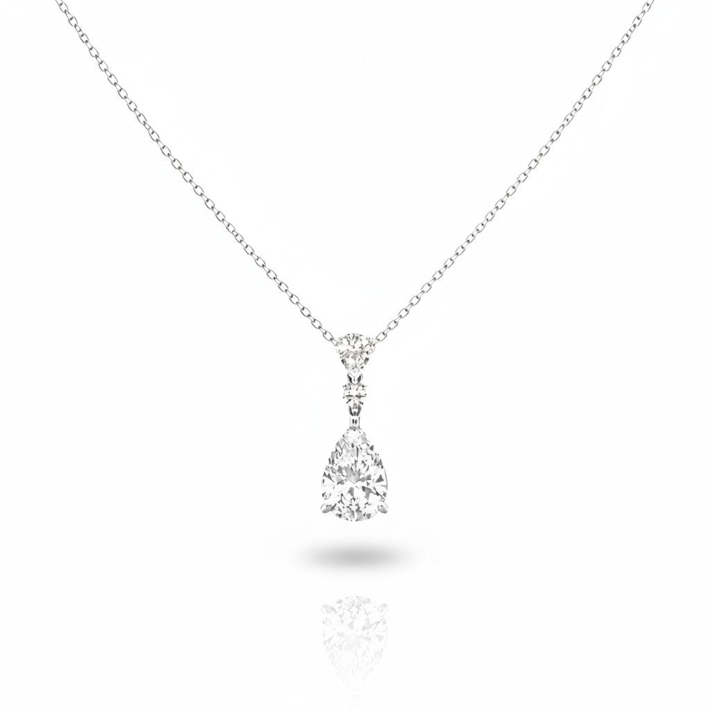 My Store 4 three-stone diamond drop necklace in 18K white gold featuring pear and round cut stones on a cable chain.