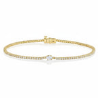 My Store 4 yellow gold tennis bracelet featuring a continuous line of round diamonds and a central pear-cut diamond.