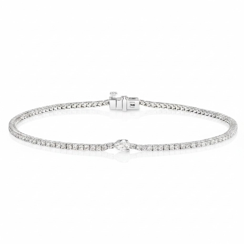 My Store 4 white gold tennis bracelet featuring a continuous line of round diamonds and a central pear-cut diamond.