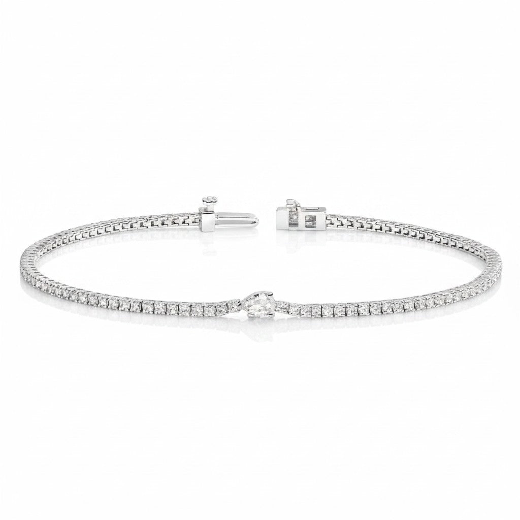 My Store 4 white gold tennis bracelet featuring a continuous line of round diamonds and a central pear-cut diamond.