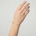 My Store 4 gold tennis bracelet featuring an alternating pattern of pear-cut and round-cut diamonds on a woman's wrist