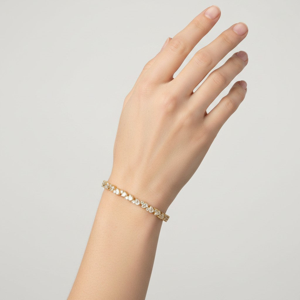 My Store 4 gold tennis bracelet featuring an alternating pattern of pear-cut and round-cut diamonds on a woman's wrist