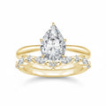 My Store 4 pear cut solitaire engagement ring with a marquise and round diamond contour band in 18K yellow gold.