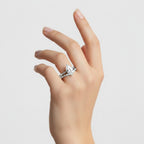 My Store 4 pear cut solitaire engagement ring with a marquise and round diamond contour band on a woman's finger.