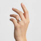 My Store 4 pear cut solitaire engagement ring and marquise contour wedding band set in 18K yellow gold on a hand.