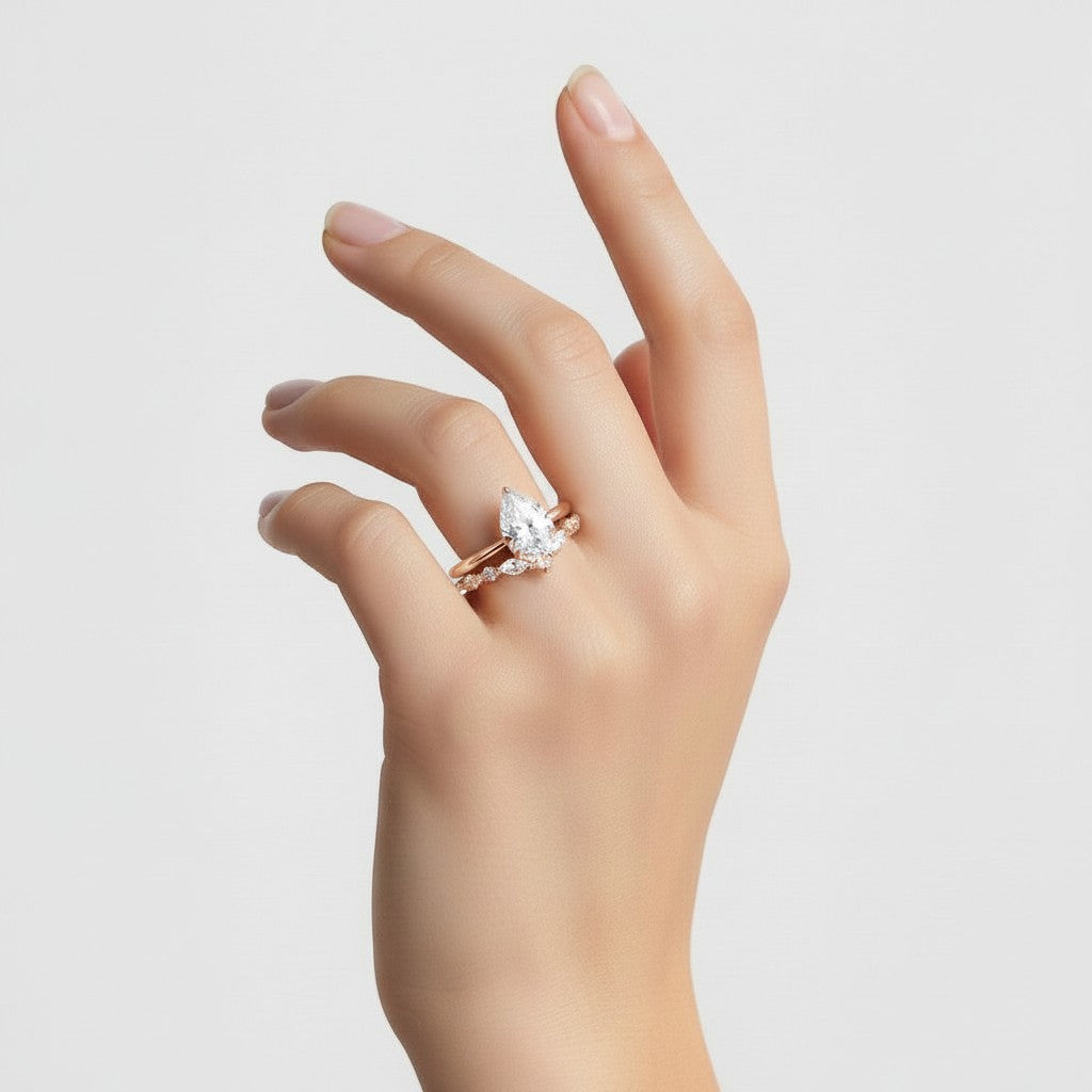 My Store 4 pear cut solitaire engagement ring with a marquise and round diamond contour band in 18K yellow gold.