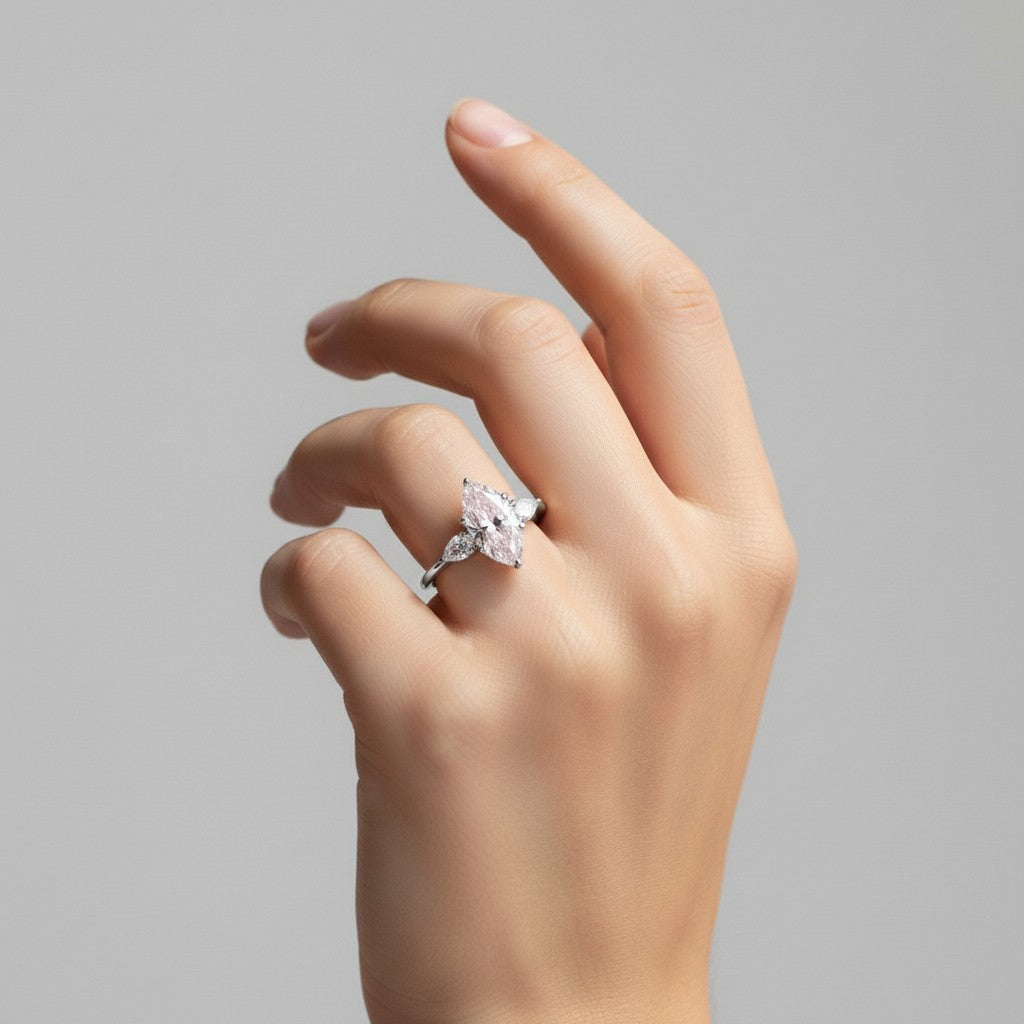 My Store 4 18K solid gold three-stone engagement ring with a pear-cut lab-grown diamond worn on a woman's finger