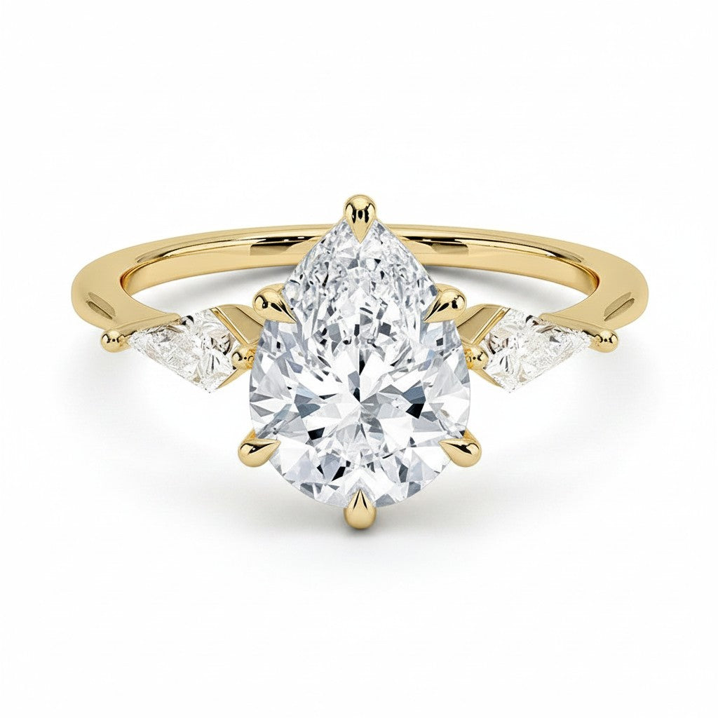 My Store 4 three-stone engagement ring with a pear-cut center diamond and pear side accents in 18K yellow gold.