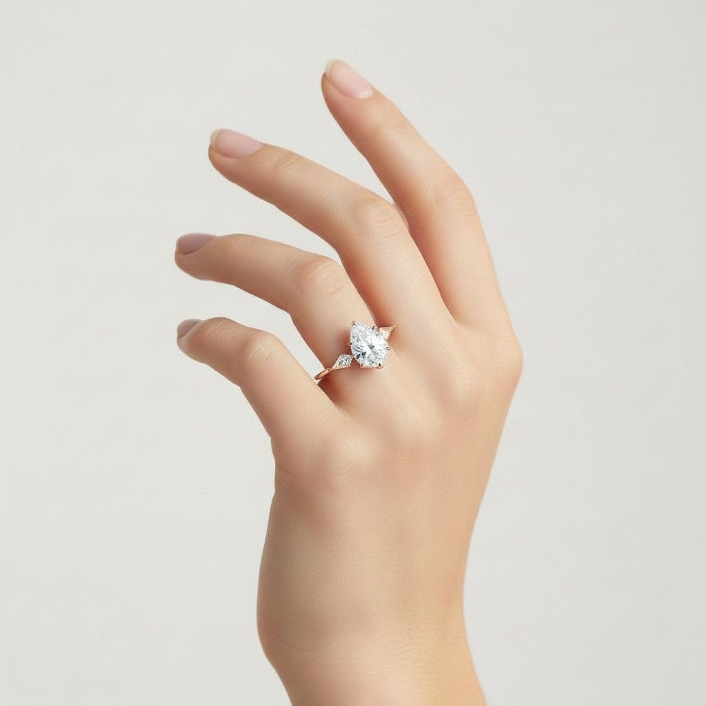 My Store 4 three-stone engagement ring with a pear-cut center diamond and pear side accents on a yellow gold band