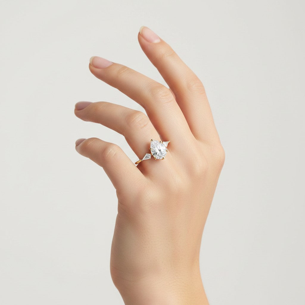 My Store 4 three-stone engagement ring featuring a pear-cut center diamond and pear side accents on a gold band.