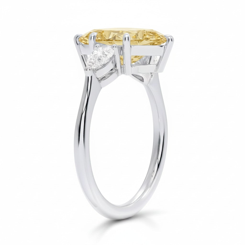 My Store 4 18K solid gold trilogy ring featuring a pear-cut fancy yellow diamond with side stones, side profile view.