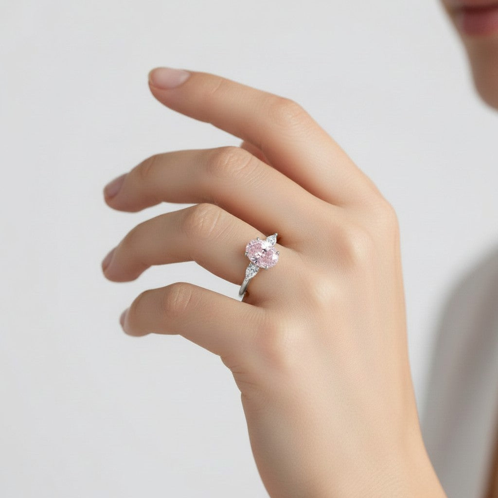 My Store 4 18K gold trilogy engagement ring featuring a pear-cut lab-grown diamond on a woman's finger