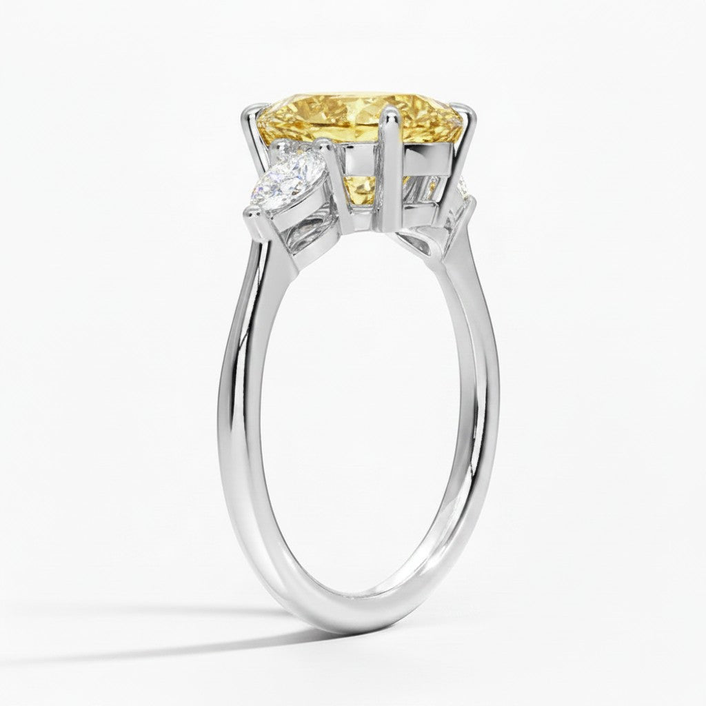 My Store 4 18K solid gold trilogy ring featuring a pear-cut fancy yellow lab-grown diamond and side stones.
