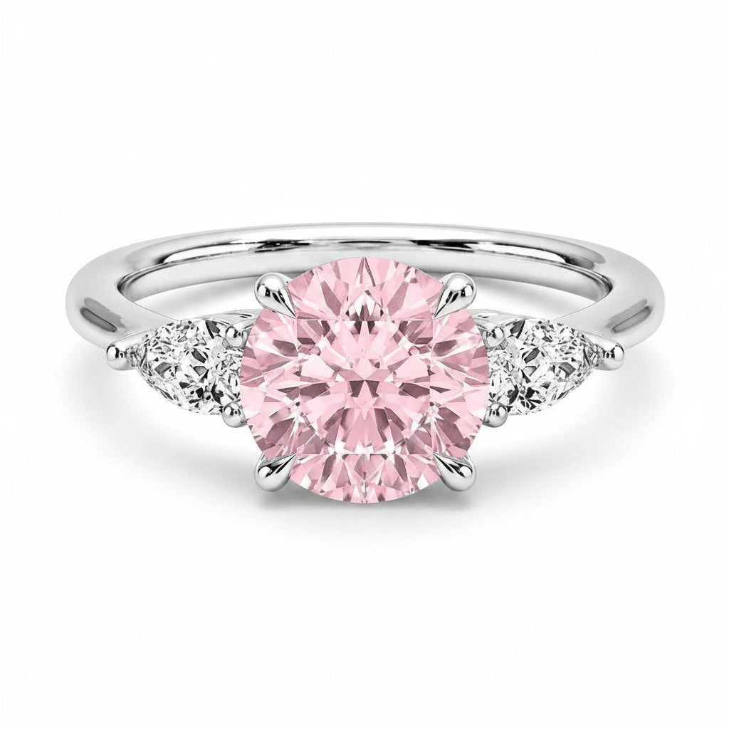 My Store 4 18K solid gold trilogy ring featuring a round fancy pink lab diamond flanked by two pear-cut side diamonds