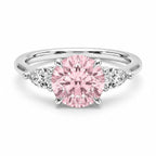 My Store 4 18K solid gold trilogy ring featuring a round fancy pink lab diamond flanked by two pear-cut side diamonds