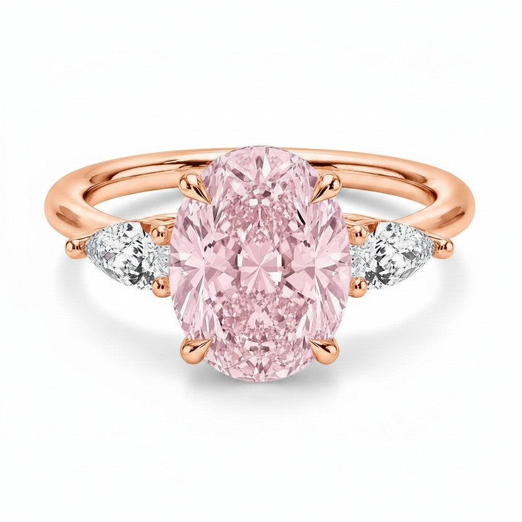 My Store 4 18K solid gold trilogy engagement ring featuring a central pink oval diamond and pear-cut side diamonds.