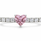My Store 4 tennis bracelet featuring a fancy pink heart-cut diamond station set between round white diamonds in gold.