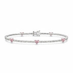 My Store 4 tennis bracelet in gold with round white diamonds and fancy pink heart-cut diamond stations.