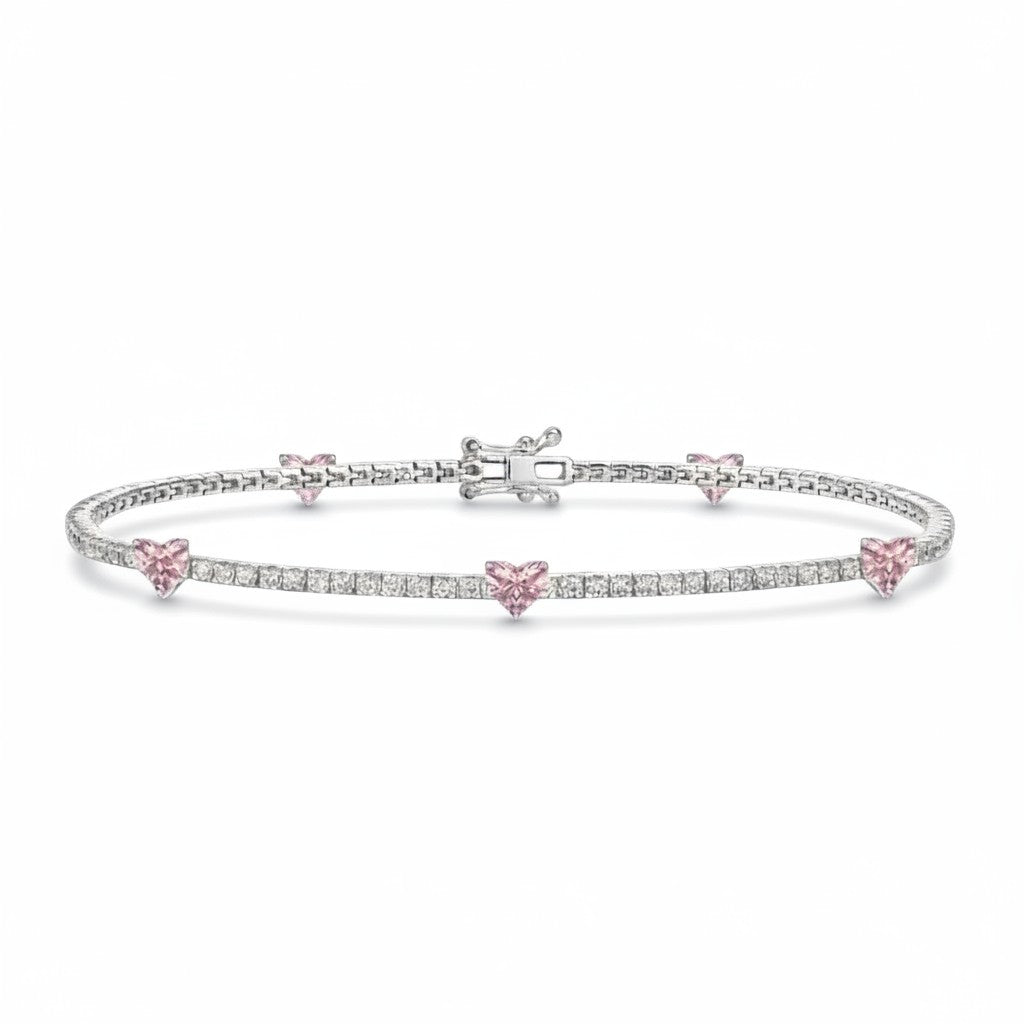My Store 4 tennis bracelet in gold with round white diamonds and fancy pink heart-cut diamond stations.