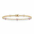 My Store 4 tennis bracelet in gold featuring round white diamonds and fancy pink heart-cut diamond stations.